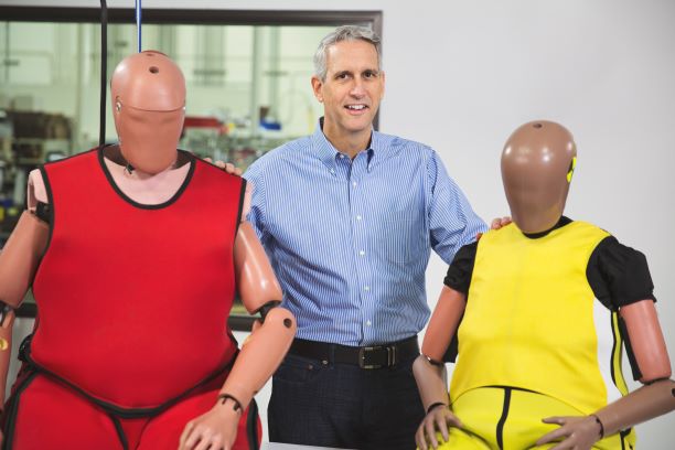 O’Connor with new-generation crash test dummies. O’Connor with new-generation crash test dummies.