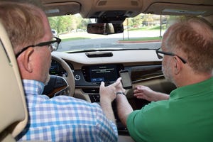 Editors Bob Gritzinger left and Drew Winter pair smartphone in Cadillac CT6