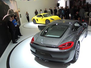 Porche unveils gray Cayman and yellow Cayman S at auto show media event