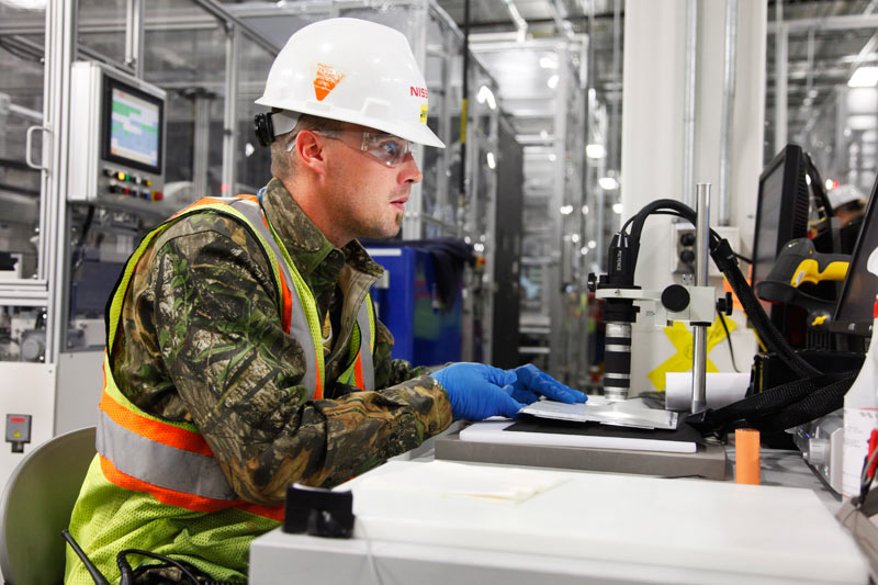 Worker in Smyrna uses microscope to inspect lithiumion battery cell Worker in Smyrna uses microscope to inspect lithiumion battery cell