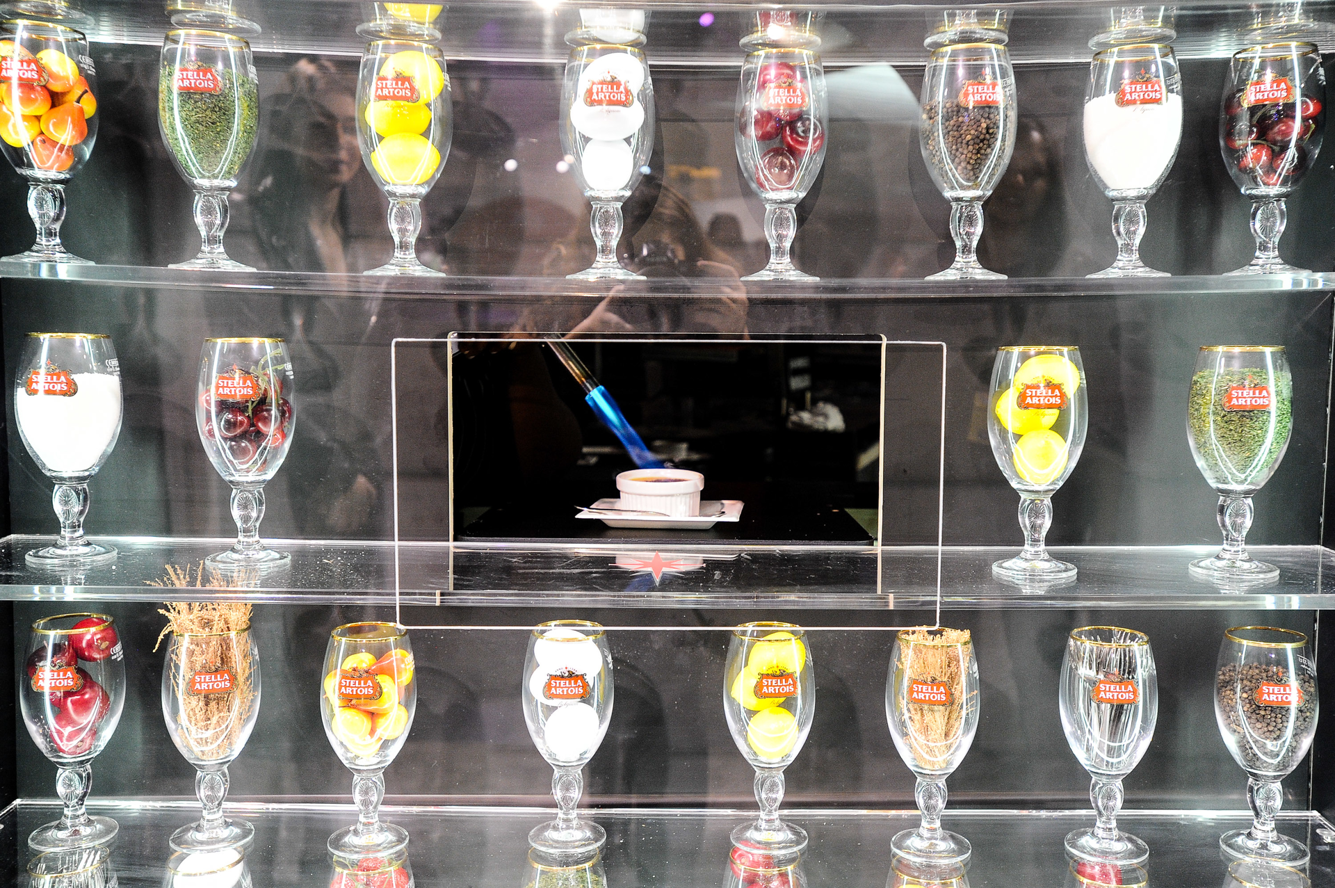 Stella Artois dispenser presenting rows of branded chalices behind glass