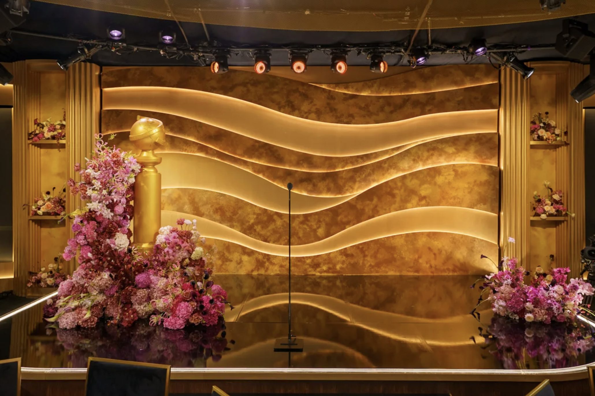 Modern luxury gold stage with premium floral installation