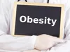 Obesity written on a blackboard in white letters Obesity written on a blackboard in white letters