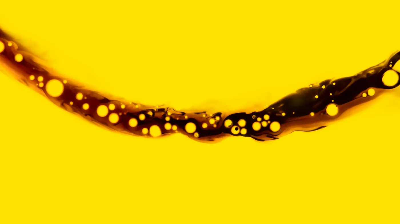 Inky brown line curving in almost a smile, with yellow bubbles, all against a yellow background Inky brown line curving in almost a smile, with yellow bubbles, all against a yellow background
