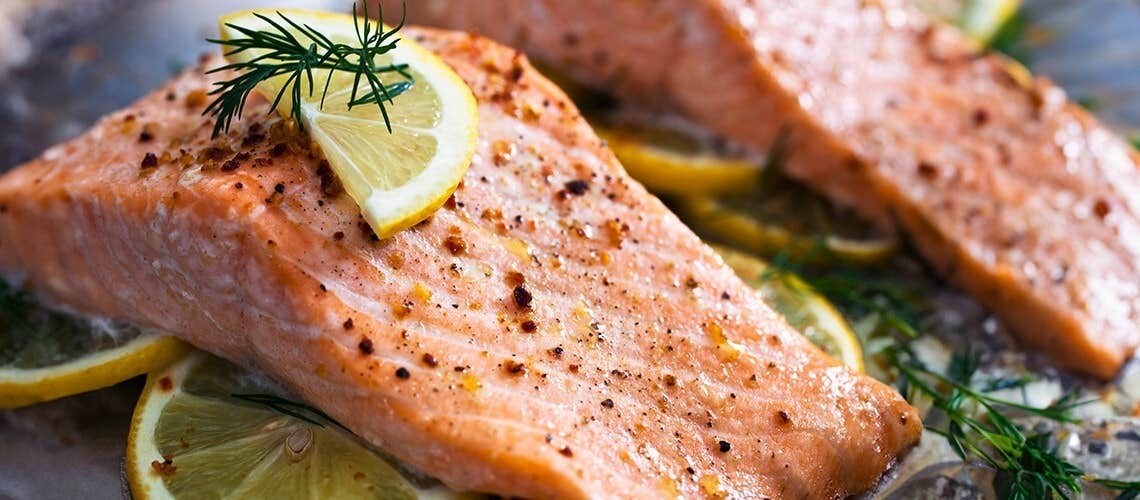 Baked salmon fillet with a lemon slice on top