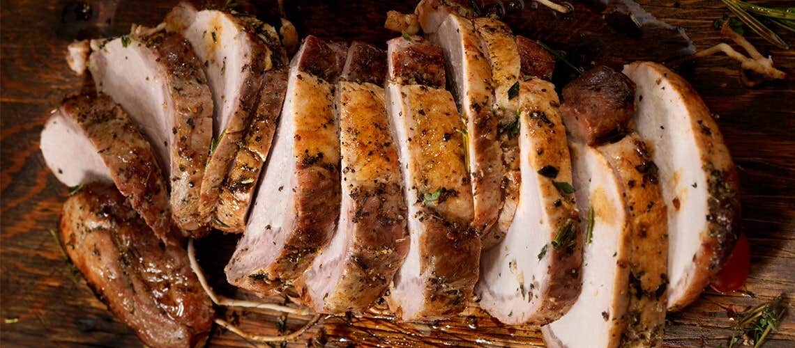 Slices of roasted pork served on a platter Χοιρινό Ψητό στο Φούρνο με Μπαλσάμικο και Βότανα