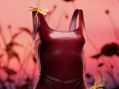Abstract graphic of red dress with a butterfly resting on the dress strap. In the background, there are shadows of flowers. 