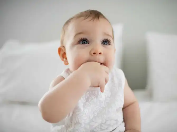 baby sucking her finger