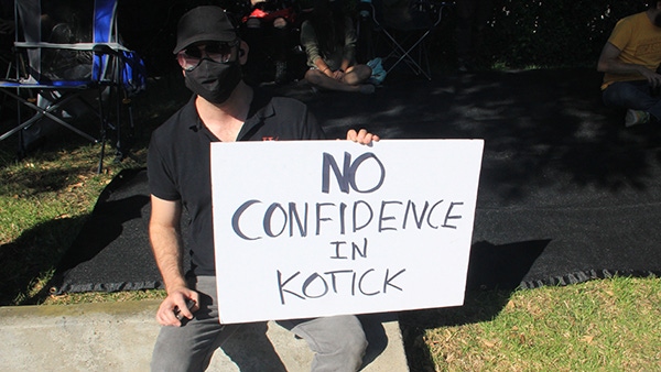 An Activision Blizzard employee holds a sign saying "no confidence in Kotick." An Activision Blizzard employee holds a sign saying "no confidence in Kotick."