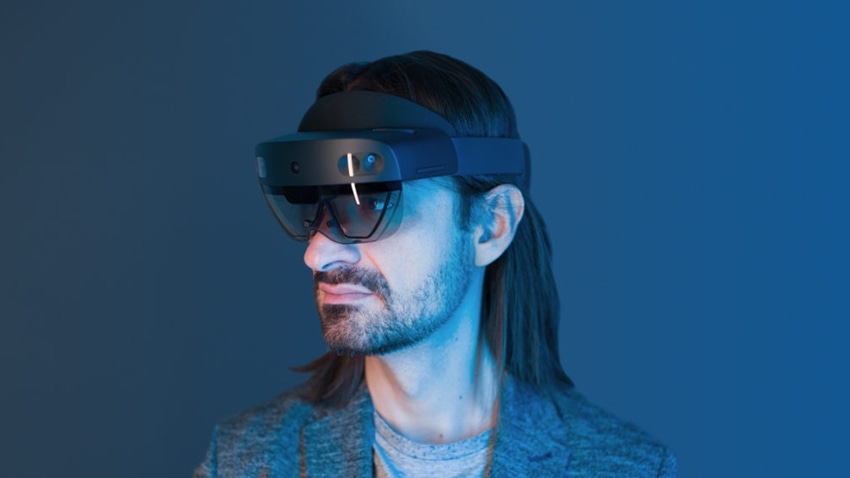 A photograph of Alex Kipman wearing a HoloLens headset