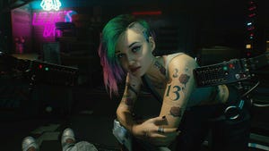 A screenshot of Judy from Cyberpunk, looking at the camera and sporting a tattoo with the number 13.