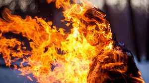 A hooded woman in flames. A hooded woman in flames.