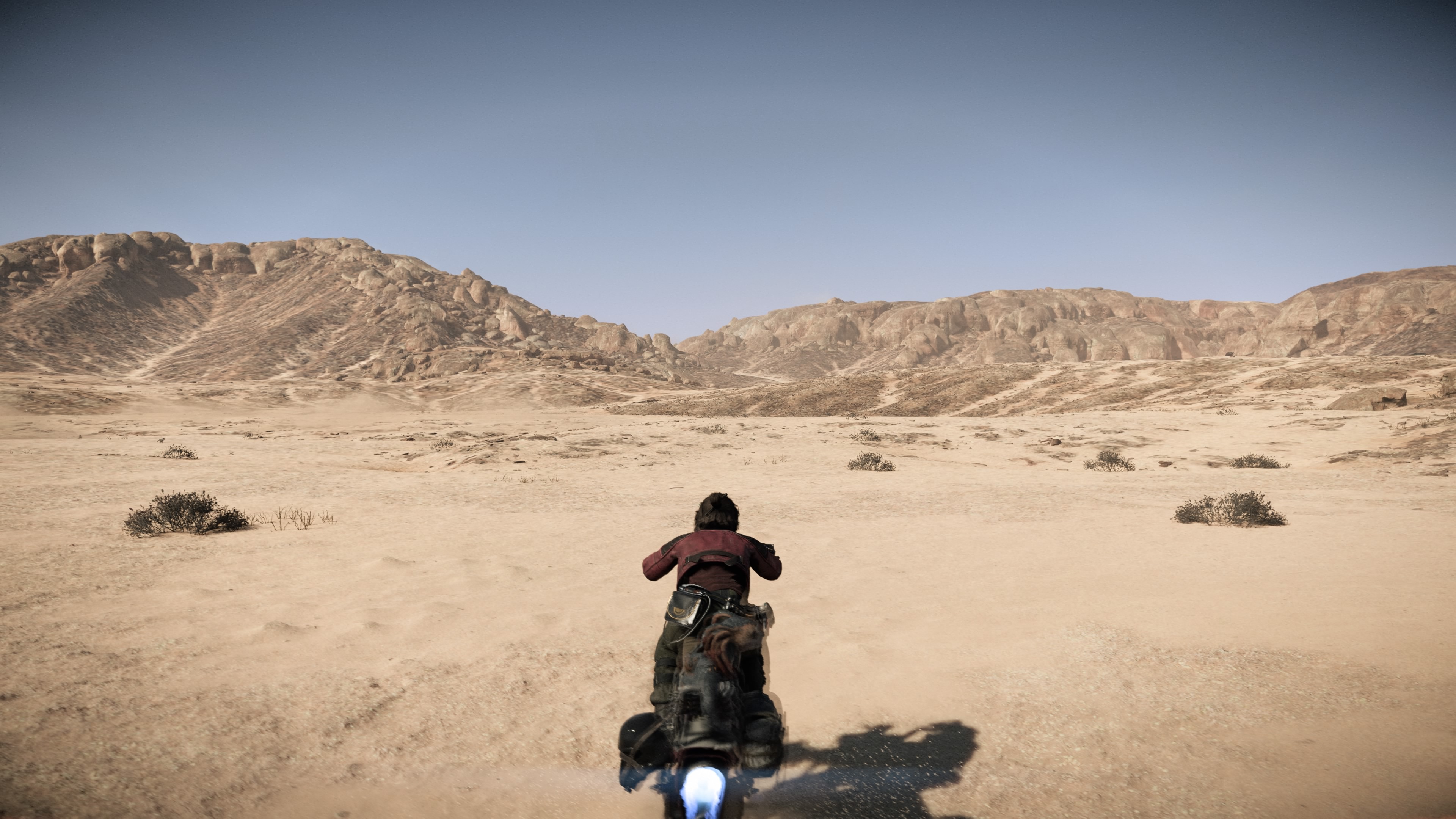 Kay Vess rides on a speeder across Tatooine