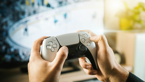 A PS5 gamepad in the hands of a player