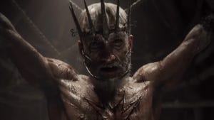 An old man with a crown piercing his head is stretched out in torture. An old man with a crown piercing his head is stretched out in torture.