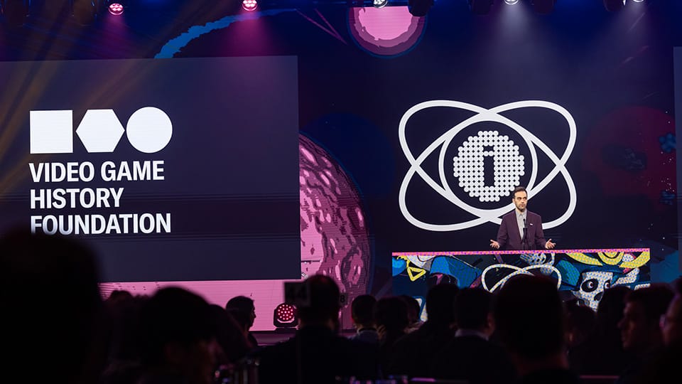 Frank Cifaldi stands at a podium with the IGF logo behind him and the Video Game History Foundation logo on the screen. Frank Cifaldi stands at a podium with the IGF logo behind him and the Video Game History Foundation logo on the screen.