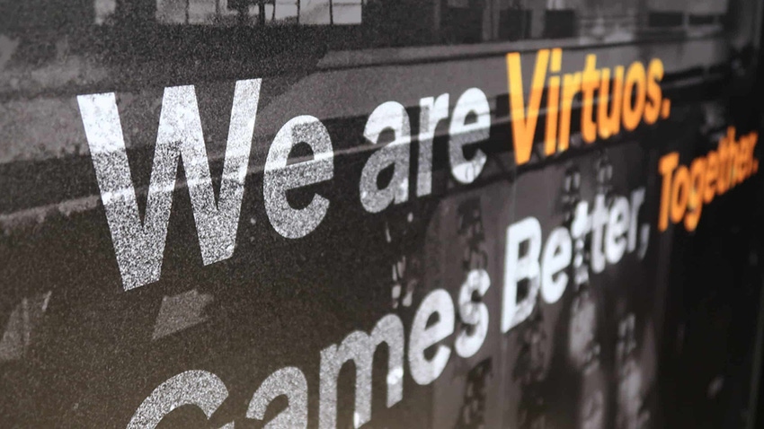 The Virtuos slogan on an office wall