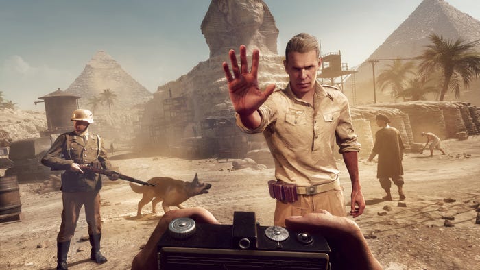 A guard holds up his hand to stop Indiana Jones, who is looking at him in first-person holding a camera in front of the sphinx and pyramids of giza. A guard holds up his hand to stop Indiana Jones, who is looking at him in first-person holding a camera in front of the sphinx and pyramids of giza.