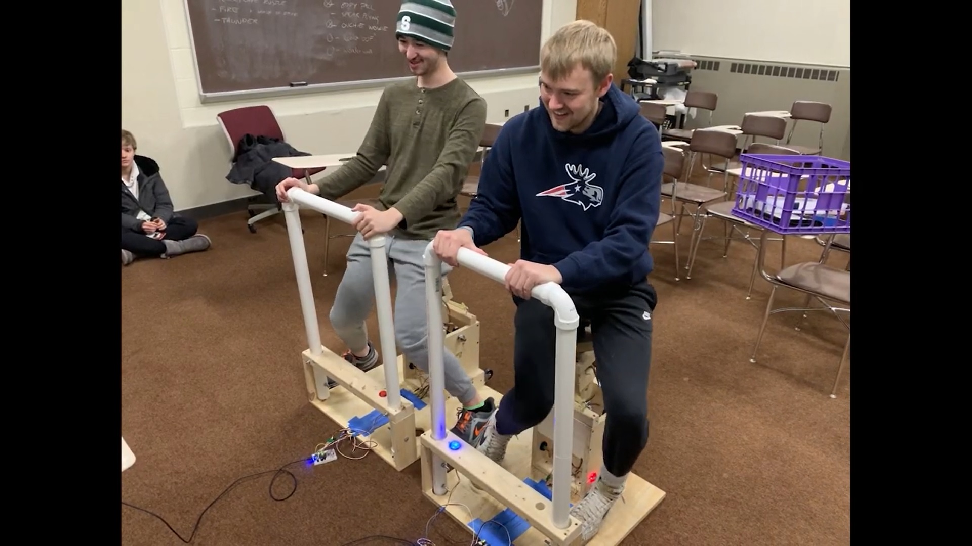 two people balancing on specialized seats to play Unicycle Samurai