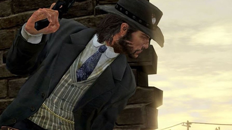 A screenshot from Red Dead Redemption. The player character crouches behind a wall while brandishing a pistol.