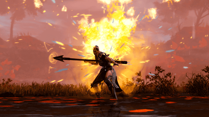 A player character wielding a spear stands in front of an explosion in Guild Wars 2.