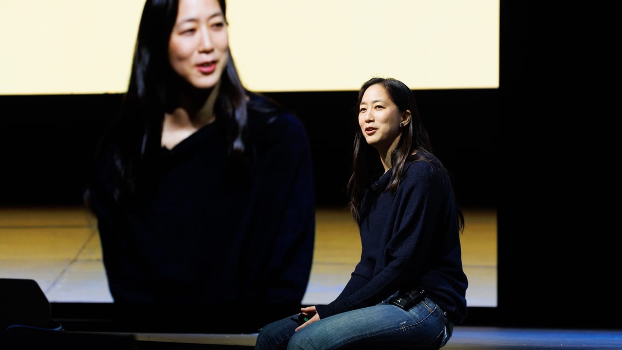 A photo of Jennifer Svedberg-Yen sitting on a stage. A photo of Jennifer Svedberg-Yen sitting on a stage.