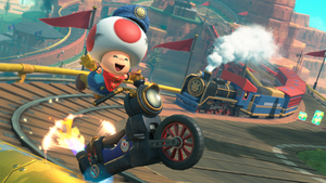 Toad jumps for joy in Mario Kart World. Toad jumps for joy in Mario Kart World.