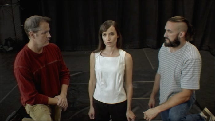 three actors standing on a stage