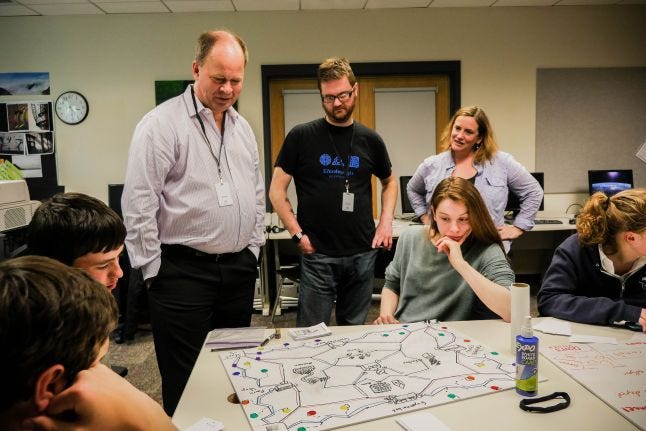 Mike Elliot consults with high schoolers on their game design.