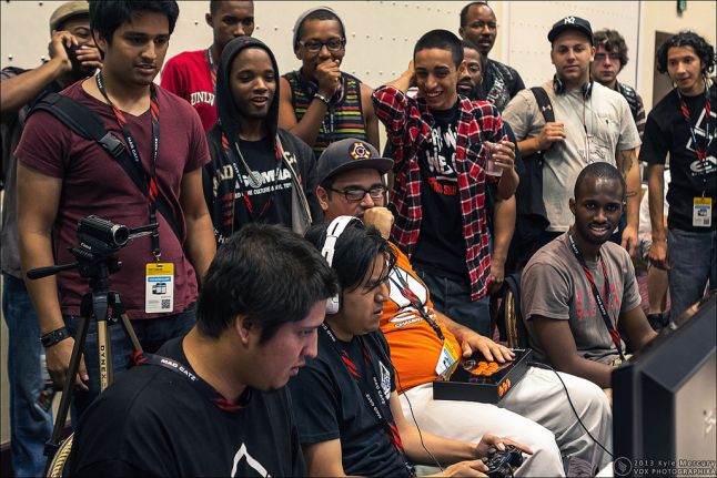 Carlos Vasquez playing while surrounded by an excited audience