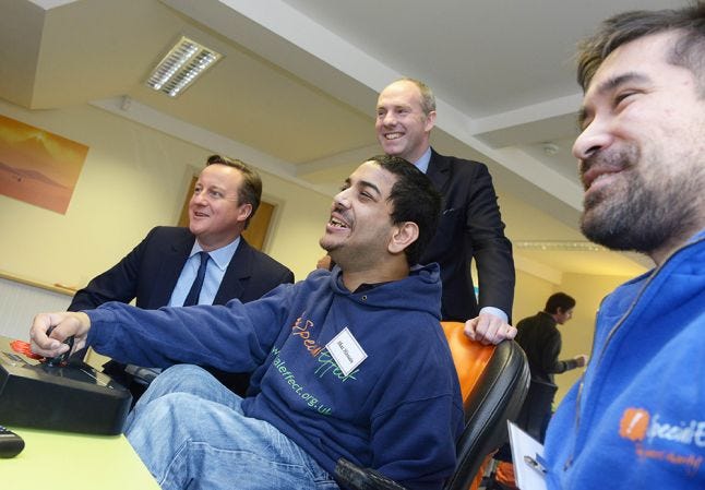 David Cameron and Justin Tomlinson recieving an assistive technology demo at SpecialEffect's new facility
