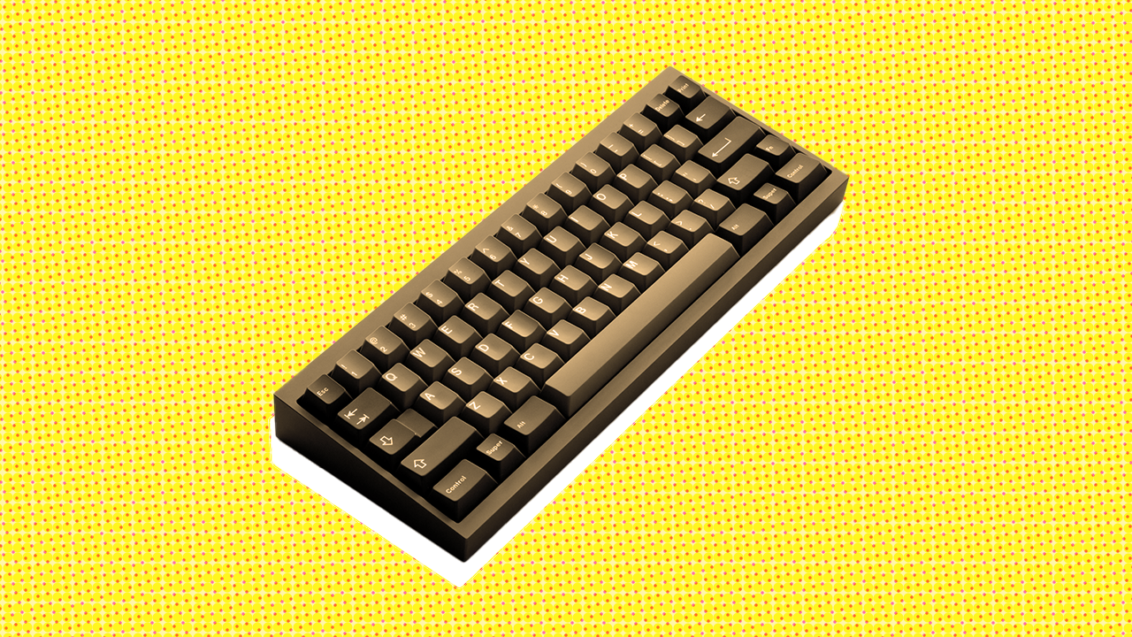 A sepia toned keyboard on a vibrant yellow background A sepia toned keyboard on a vibrant yellow background