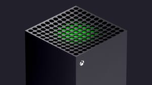 The top of an Xbox Series X, with green glowing from within The top of an Xbox Series X, with green glowing from within