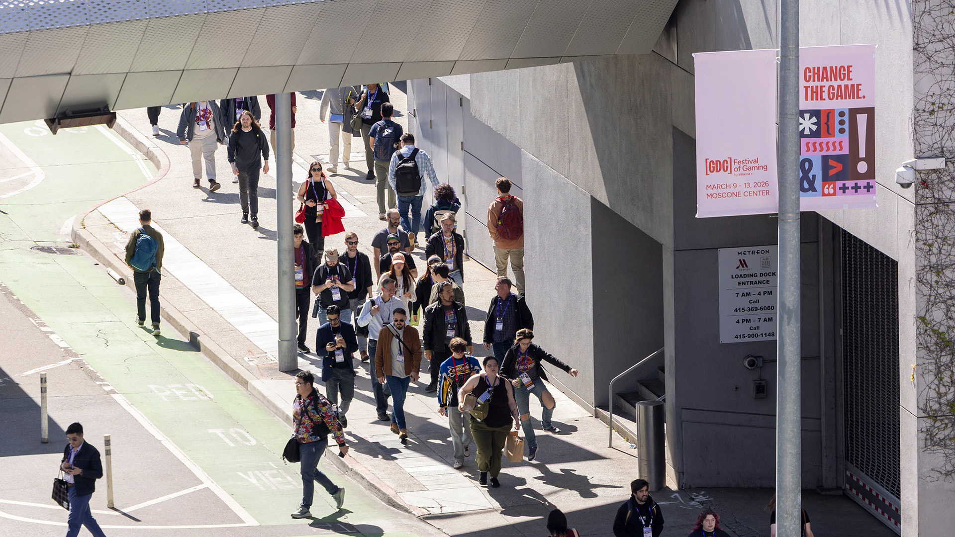 A shot of the GDC crowd, one person does a jump-skip on the street