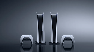 Two PlayStation 5s, the regular and the digital editions, sit vertically along two DualSense controllers Two PlayStation 5s, the regular and the digital editions, sit vertically along two DualSense controllers