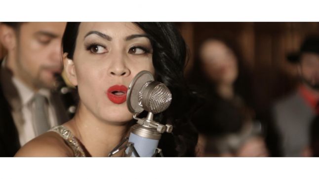 Boossara performing with a microphone.