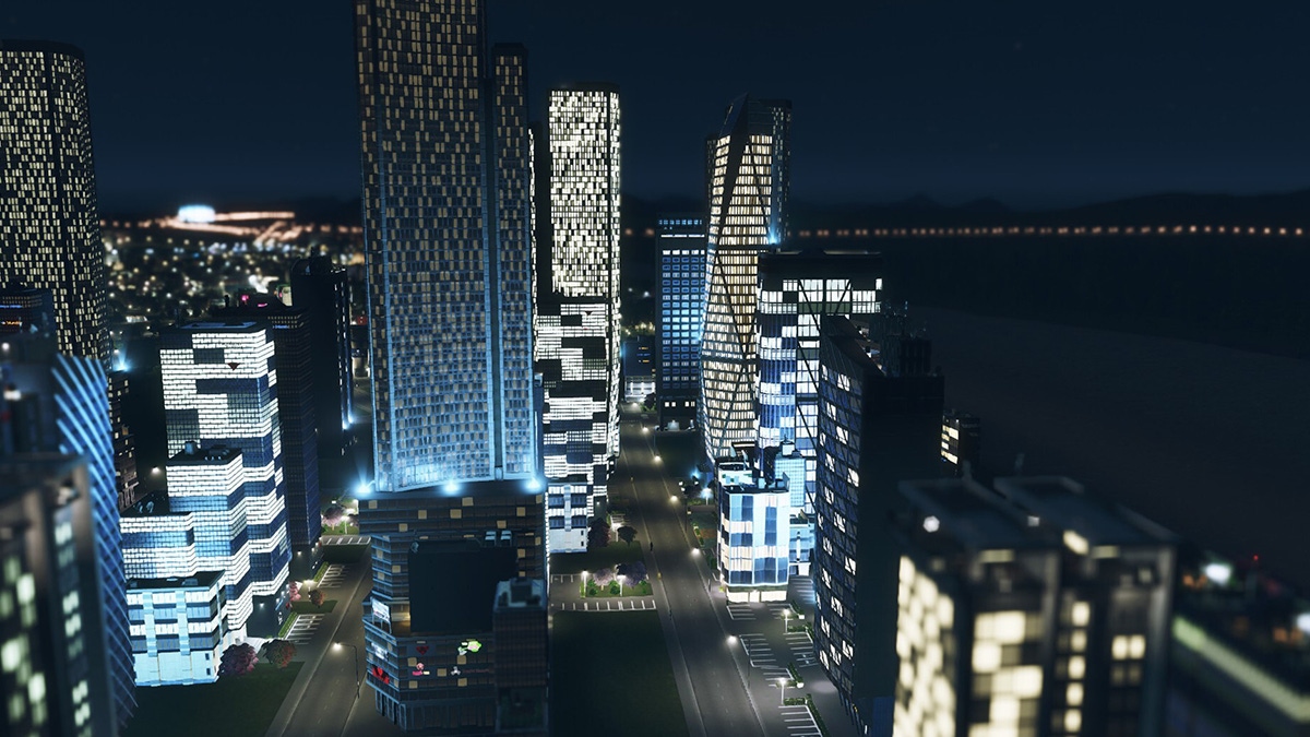 A screenshot from Cities: Skylines showing a panoramic vista of a skyscraper cluster at night A screenshot from Cities: Skylines showing a panoramic vista of a skyscraper cluster at night
