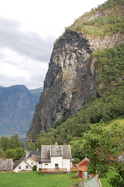 A picture of a Norwegian farm set against the fjords.