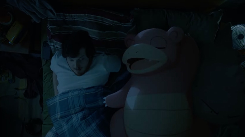 A human wakes abruptly next to a slumbering Slowbro