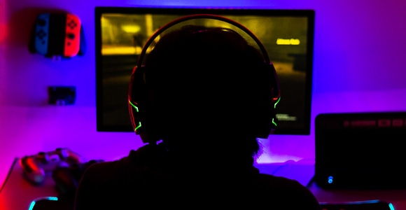 A backlit player with a headset on