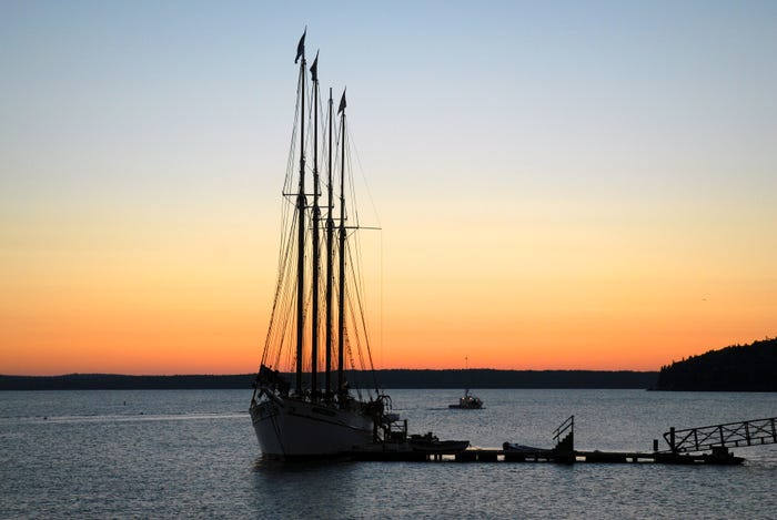 A tall ship docked at sunset. A tall ship docked at sunset.