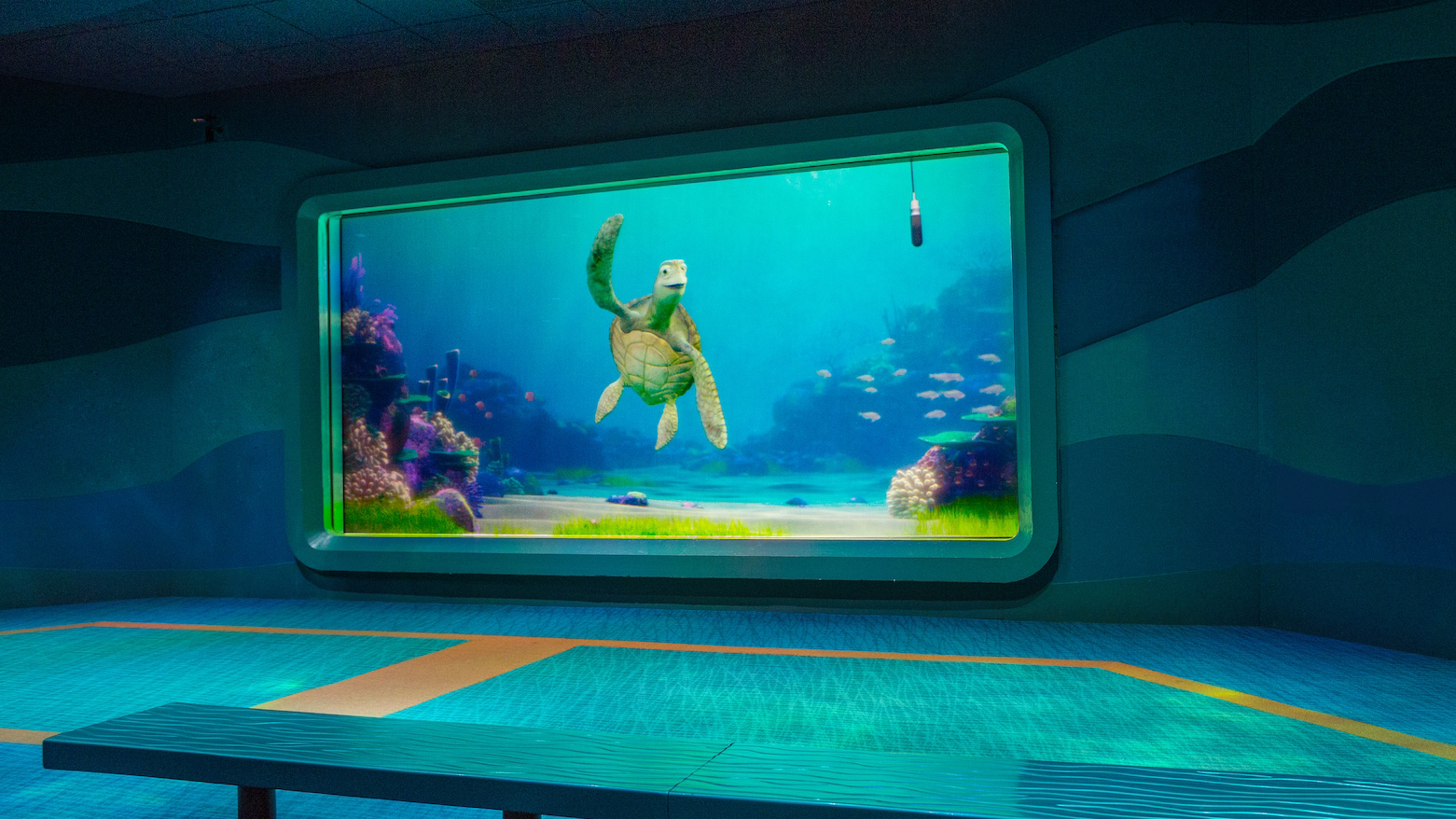 The Disney attraction Turtle Talk With Crush. An animated sea turtle waves at the camera.