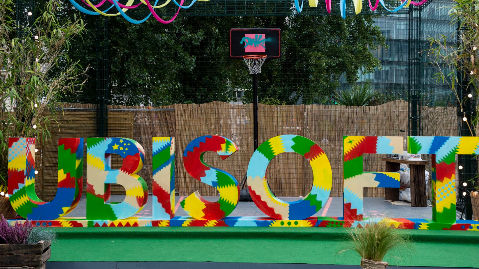 The word Ubisoft is colored and being displayed outdoors of the company's offices