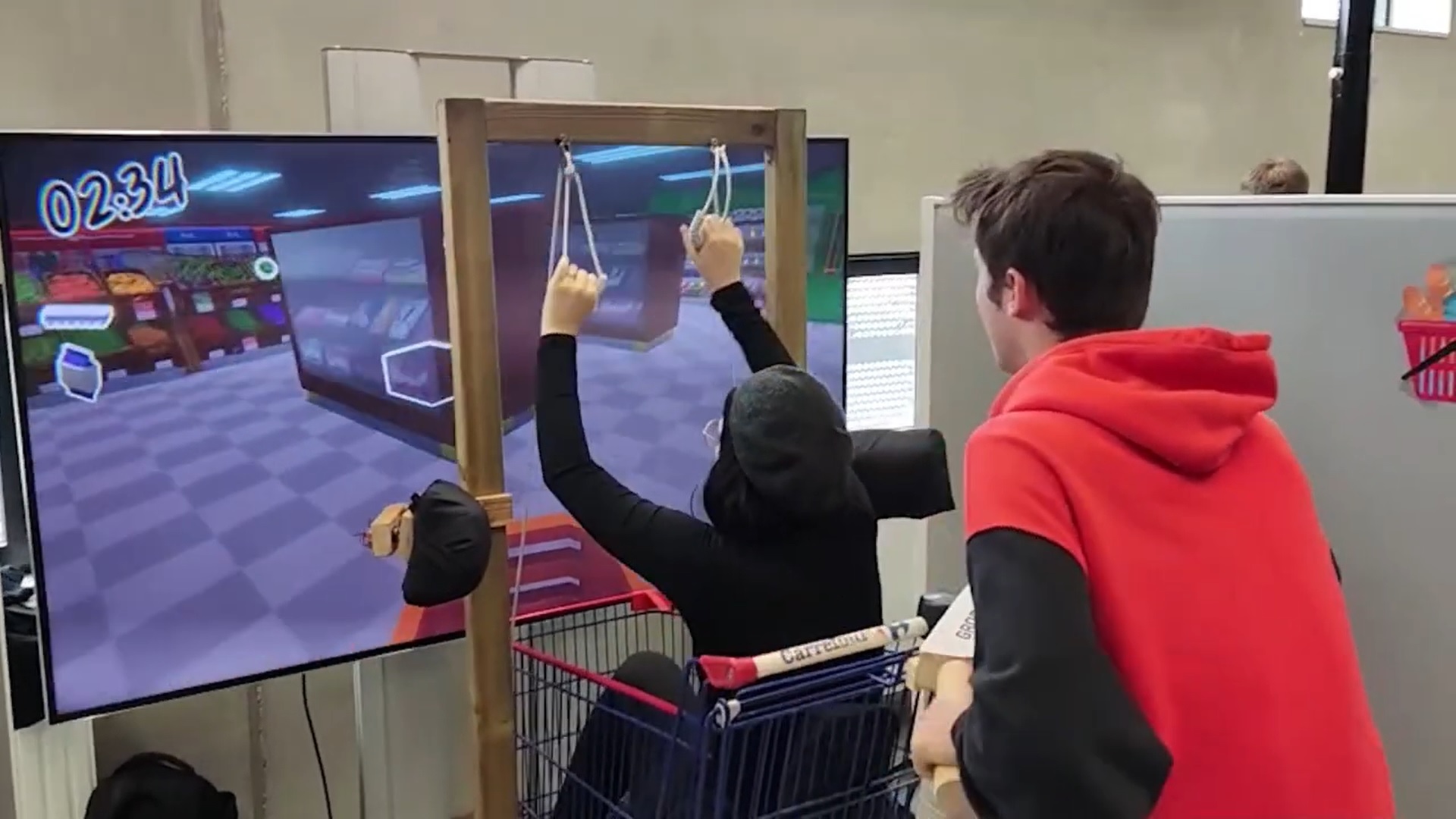 a person pushing a shopping cart while someone inside the cart works some pulleys