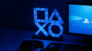 The PlayStaton logo in the form of a blue neon sign placed on a desk The PlayStaton logo in the form of a blue neon sign placed on a desk