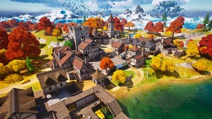 A screenshot from Fortnite. A medieval town sits in the foreground with snow-white mountains in the background.