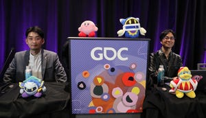 two seated men smile and look at camera next to four stuffed toys from the Kirby video game series