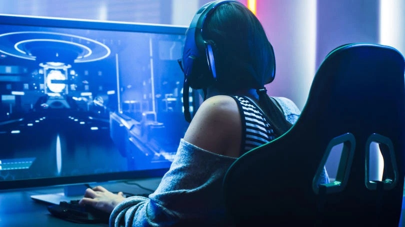 Silhouette of a person working with Unity, in blue light Silhouette of a person working with Unity, in blue light
