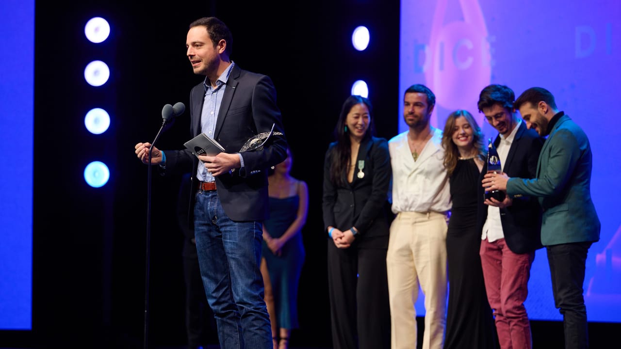 The Sandfall Interactive developers and voice actors accept an award at the DICE Awards. The Sandfall Interactive developers and voice actors accept an award at the DICE Awards.