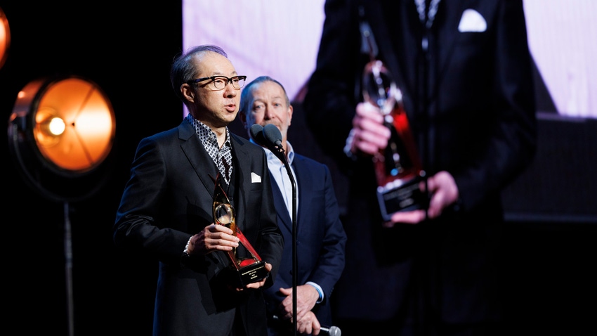 Koji Kondo and his translator stand onstage at the 2024 DICE Awards.